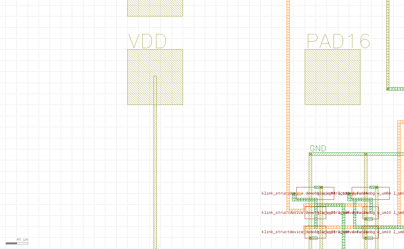 放大左下角：VDD pad 下方一条竖直的黄色 strap 走廊接到电网 tie rail，右侧是 GND rail 和器件